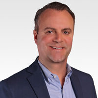 A headshot of Adam Mansfield