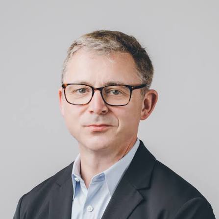 A headshot of Adrian McDermott