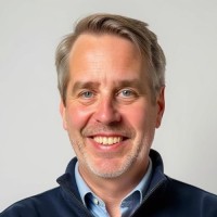 A headshot of Derek Top