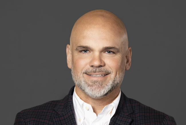 A headshot of Jason Maynard